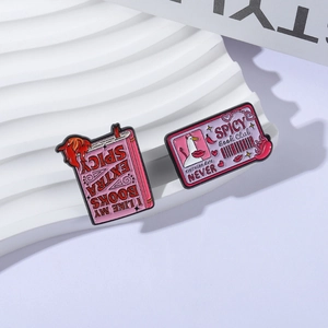 Spicy Book Club enamel pin set with pink book and membership card on display