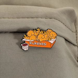 Detail of creative metal enamel pin featuring a fried chicken dog design on a canvas bag