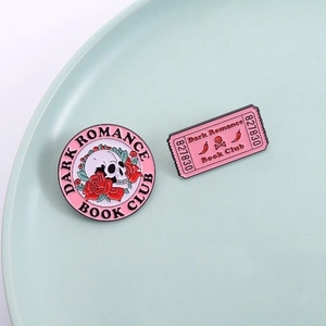 Gothic skull and rose enamel pin set with Dark Romance Book Club engraving on green background