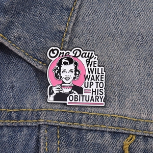 Detail of vintage cartoon woman enamel pin with text pinned on blue denim jacket