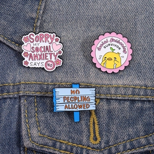 Three-piece social anxiety enamel pins set with funny duck on denim jacket fabric