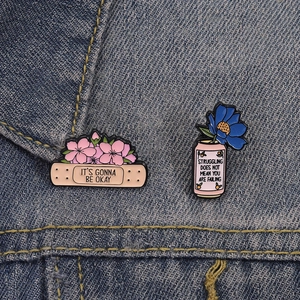 Macro detail of mental health healing enamel pins on a denim jacket with inspirational text