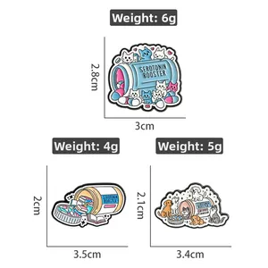 Detail showing enamel cat pins with precise weight and size measurements for product dimensions