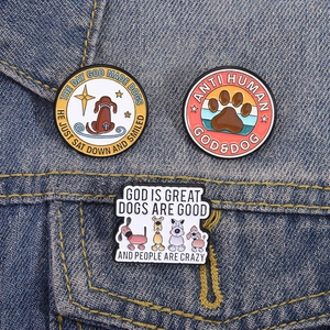 Funny enamel dog brooches set on blue denim fabric featuring cartoon dog illustrations