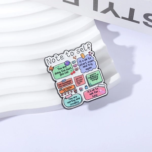 Pin de esmalte colorido con frases motivadoras y diseño de cuaderno creativo