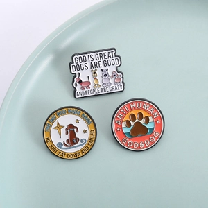Three-piece set of cartoon enamel dog brooches with inspirational English text on a tray