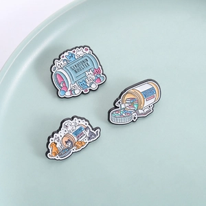 Three-piece serotonin booster enamel pins featuring cute cat, book, and dog designs