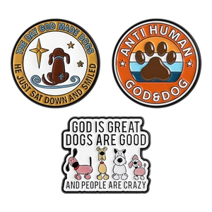 Three funny enamel dog pins with creative quotes and paw prints on white background