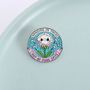 Funny dandelion enamel pin with Hanging In There text and spiteful expression
