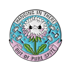 Angry dandelion enamel pin with Hanging In There and Out Of Pure Spite text