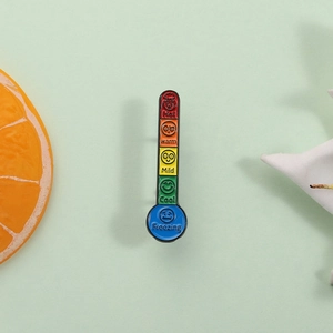 Creative thermometer enamel pin with colorful mood emojis and temperature scale