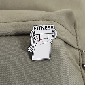 Detail of funny white cartoon figure fitness enamel pin pinned on a green canvas bag
