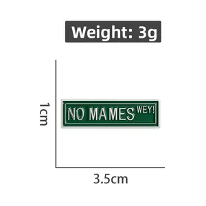 Dettaglio delle dimensioni 3,5x1cm della spilla in metallo verde con testo No Mames Wey
