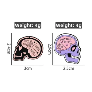 Detail view of pink and purple skull enamel pins showing dimensions and 4g weight specs