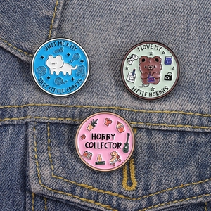 Detailed view of colorful animal enamel pins on a denim jacket pocket showcasing badges