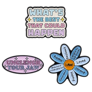 Set of three colorful enamel pins featuring inspirational quotes and a blue daisy design
