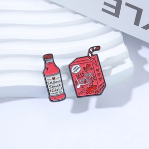 Cute self-love enamel pin set featuring red juice box and spicy sauce bottle designs