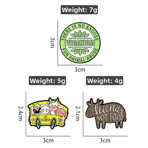 Detailed view of three vegan enamel pins with weight and size dimensions on white backdrop