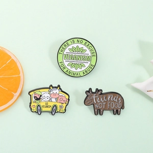 Enamel pins set with animal bus and veganism slogans on light green background