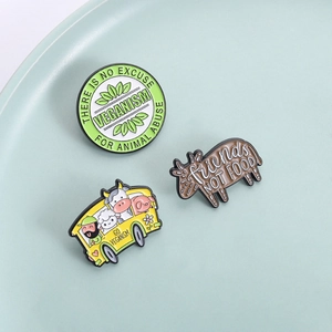 Three-piece vegan enamel pin set featuring farm animals and Go Veganism bus slogan