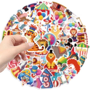 Close-up of a hand holding a circus tiger sticker over a vibrant pack of decals