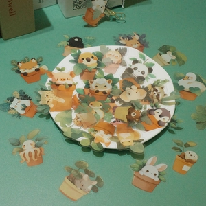 Macro view of clear waterproof PET stickers featuring cute cartoon animal potted plants