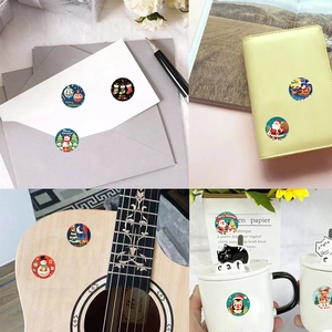 500pcs Christmas stickers roll with Santa and reindeer on envelope, cup and laptop