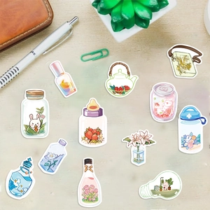 Detailed view of waterproof cartoon stickers with cute bottle designs on a desktop