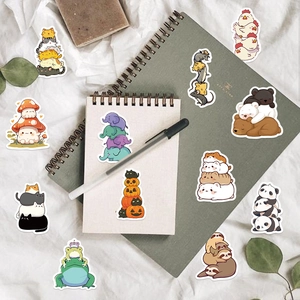 Detailed flat lay of cute cartoon animal stickers on a notebook with office props