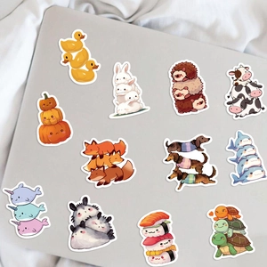 Waterproof cartoon animal stickers on a grey laptop surface for DIY decoration