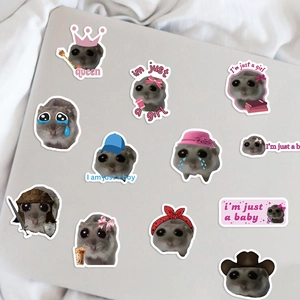 Detail of waterproof sad hamster meme stickers with cute accessories on a laptop surface