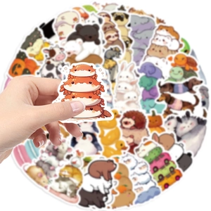 Close-up of hand holding a waterproof cartoon crab sticker from a colorful animal variety pack