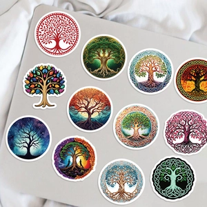 Close-up of vintage Tree of Life stickers applied to a gray laptop cover with Celtic patterns