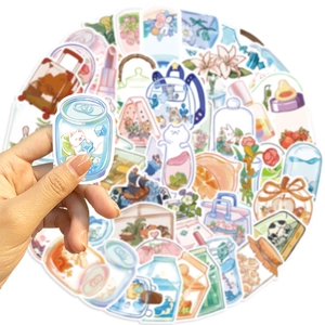 Close-up of cute cartoon stickers being held, showing waterproof PVC material and details