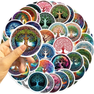 Close-up of a hand holding a round tree of life sticker with vibrant Celtic patterns