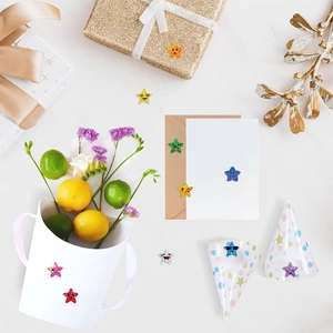 Close-up of glitter star reward stickers with cartoon faces on a festive gift gift box