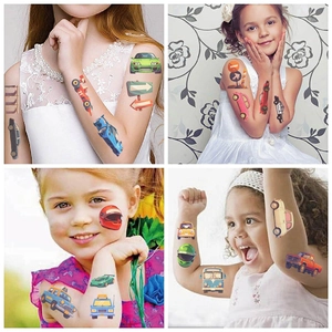 Gros plan de tatouages temporaires de véhicules de dessins animés sur le bras d'un enfant