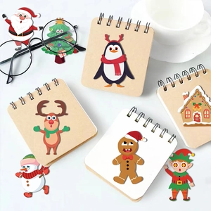 Detailed view of colorful Christmas stickers featuring snowman and reindeer on craft notebooks