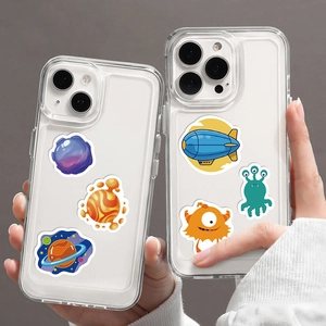 Detailed view of clear smartphone cases with colorful cartoon astronaut and alien prints
