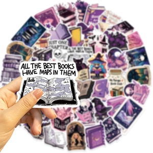 Close-up of purple witchy book stickers for laptop and guitar with magic quotes