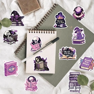 Gothic witch stickers set featuring skulls and magic books on a spiral notebook