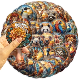 Close-up of translucent round animal stickers in stained glass style with sunflower detail