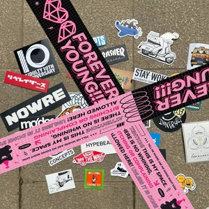 Macro shot of waterproof warning sign stickers and Forever Young decorative tape rolls