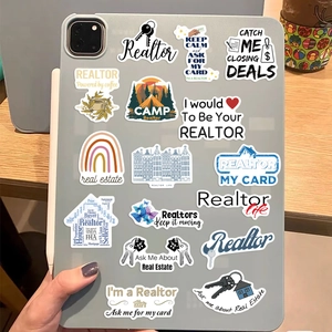 Detail of waterproof realtor stickers applied on the back of a laptop and tablet