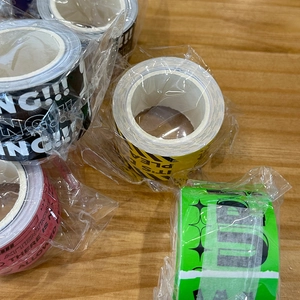 Detail of four colorful waterproof warning tapes with Attention and NG text patterns