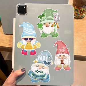 Cute cartoon gnome waterproof stickers applied on a grey tablet for DIY decoration