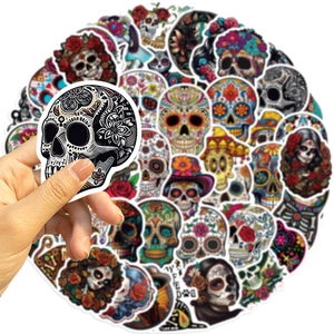 Detail of Day of the Dead sugar skull stickers being held to show size and texture