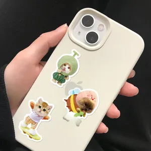 Detail of cute cat meme stickers on a beige phone case showing funny cartoon kitten designs