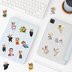 Funny cartoon cat stickers decorating a blue tablet case and laptop on a desk