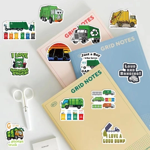 Close-up of waterproof garbage truck stickers with vivid colors on grid notebooks